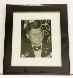 Photo of President Kennedy smiling.